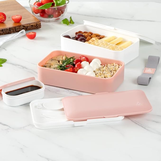 Restaurantware Bento Tek 40.5 Ounces Stackable Lunch Box 1 Reusable Adult Lunch Container - With Utensils Included Sauce Cup Pink & White Plastic Layered Lunch Box Microwavable Dishwashable