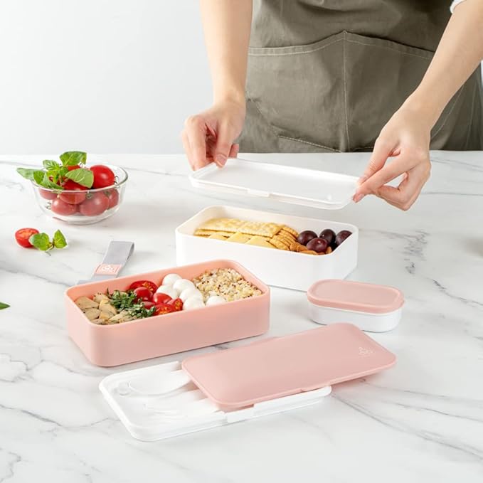 Restaurantware Bento Tek 40.5 Ounces Stackable Lunch Box 1 Reusable Adult Lunch Container - With Utensils Included Sauce Cup Pink & White Plastic Layered Lunch Box Microwavable Dishwashable