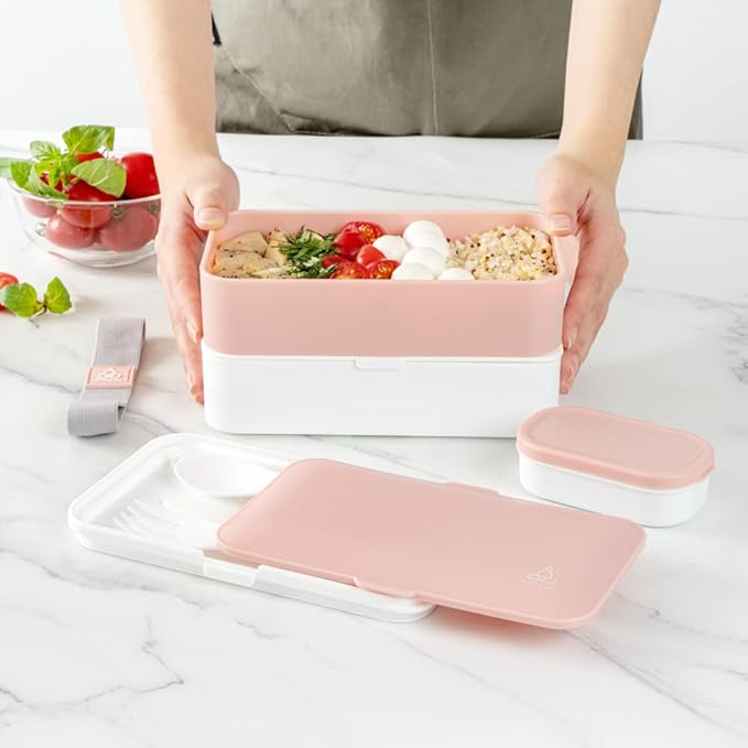 Restaurantware Bento Tek 40.5 Ounces Stackable Lunch Box 1 Reusable Adult Lunch Container - With Utensils Included Sauce Cup Pink & White Plastic Layered Lunch Box Microwavable Dishwashable