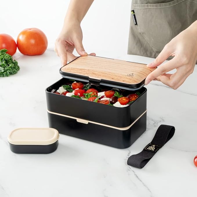 Restaurantware Bento Tek 40.5 Ounces Stackable Lunch Box 1 Reusable Adult Lunch Container - With Utensils Sauce Cup Wood Grain & Black Plastic Layered Lunch Box Microwavable Dishwashable